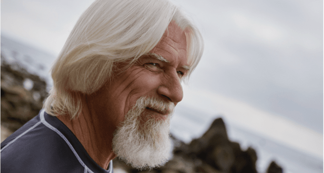 Man smiling and enjoying the beach view Man with a smile enjoying the beach view